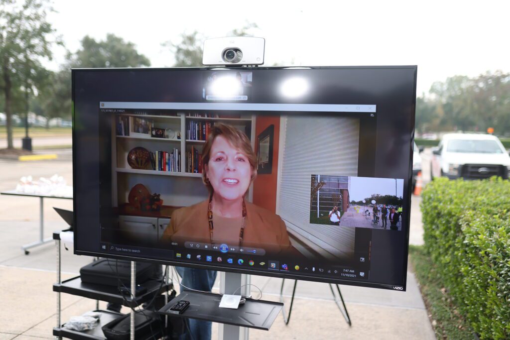 Carol Eggert displayed on an outdoor TV.